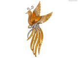 une image représentant une broche en forme d'oiseau en or, ornée de diamants sur les ailes