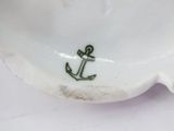 a white plate with an anchor on it on a table