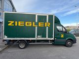 a green truck that is parked in a parking lot