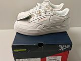 a box with a pair of white shoes on top of it