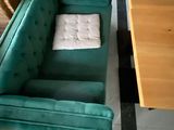 a green couch and a wooden table in a room