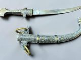 pair of old and rusty knifes on a white surface