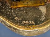a close up of a gold statue of a man