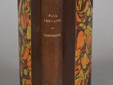 an old book with a brown cover sitting on top of a table