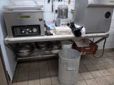 a kitchen with a lot of pots and pans on the counter