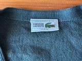 the label is on the back of a sweater on a wooden table