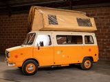 an orange van with a brown box on top of it
