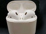a pair of airpods sitting in a case on a black surface