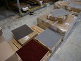 several boxes of carpet are stacked on pallets in a warehouse