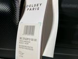 a luggage tag attached to the handle of a suitcase