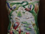 a decorative container with a painting of birds and flowers on it
