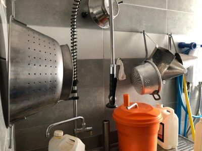 pots and pans are hanging on a wall in a kitchen