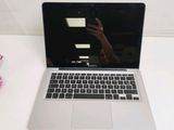 a laptop that is sitting on a table with a cell phone