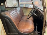 an old car with a leather seat and steering wheel