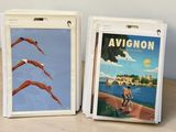 pair of vintage avignon travel posters on display on a wooden table
