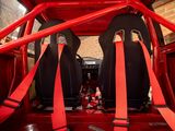 two red seats in the back of a red car
