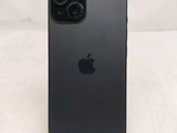 a close up of a black iphone sitting on top of a wooden table