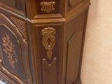 an antique wooden cabinet with a carved design on the front