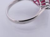 a close up of a ring with a pink stone in it
