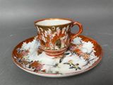 a cup and saucer on a saucer on a table