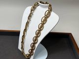 un gros plan d'un collier posé sur un présentoir posé sur une table