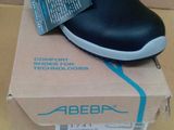 black and white slip on shoes in a box on a table