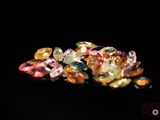 some very pretty colored diamonds on a black surface