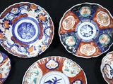 several plates with different designs on them on a black surface