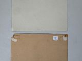 two pieces of cardboard with a piece of paper on top of it