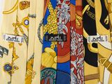 several different colored ties with different designs on them on a white surface
