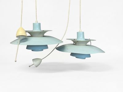 two blue and yellow pendant lights hanging from a white ceiling