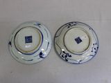 pair of blue and white plates on a white table cloth