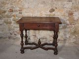 a small wooden table with a drawer on top of it