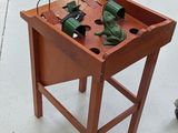 a small wooden table with a bunch of tools on it