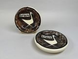 pair of brown and white ceramic plates with a black and white design