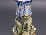 a blue and white vase with a bird on it