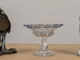 three vases and a clock sitting on a table