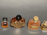 many different perfume bottles lined up on a table