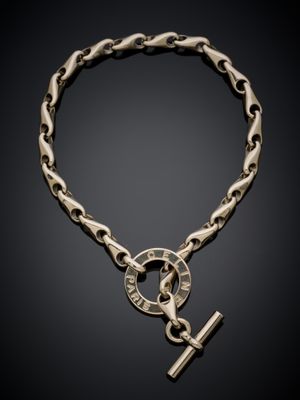 un gros plan d'un bracelet à maillons orné d'une croix