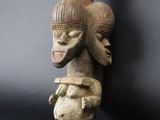 an image of a wooden sculpture of a bird and a bird on top of it