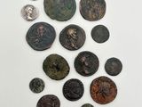 a group of ancient coins on a white surface with a white background