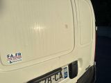a white van with a sticker on it parked in a parking lot