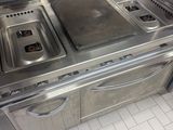 a kitchen with two sinks and a stove in it
