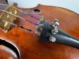 a close up of a violin with strings attached to it
