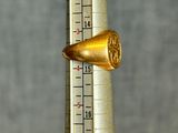 a thermometer with a gold ring on top of it