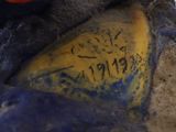 a blue and yellow statue with writing on it