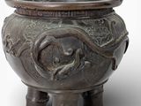 a large bronze pot with a dragon design on it