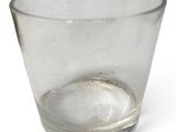 a clear glass cup with a small amount of water in it