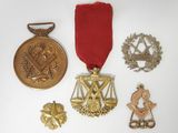 three medals and a medal are on a white surface