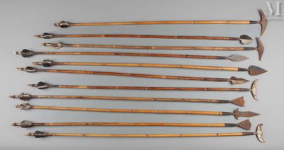 six wooden arrows are arranged in a row on a gray surface